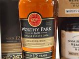 a bottle of whisky next to a box of wine