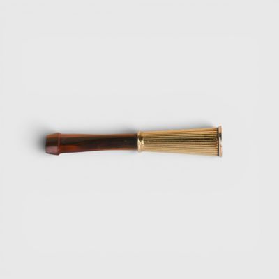 a close up of a pen on a white surface with a white background