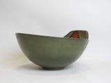 green bowl with a red flower in the center on a white background