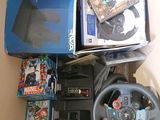 a box with a steering wheel, a game controller, a game and a box of games