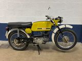 a yellow and black motorcycle parked in a garage