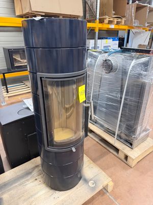 a black stove sitting on a pallet in a warehouse