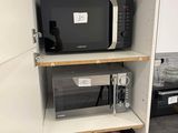 a microwave and a microwave oven in a small kitchen