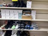 many pairs of shoes on the shelves in the store