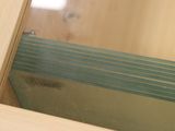 a close up of a mirror in a wooden cabinet