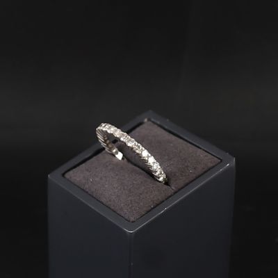 a close up of a ring in a black box on a black surface
