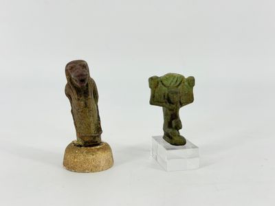 two small figurines of a man and a woman on a pedestal