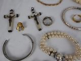 many different types of jewelry on a white table