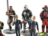 many figurines of different types of fire fighters on display