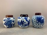 three blue and white vases sitting on top of a table