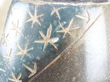 a close up of a vase with a star design on it