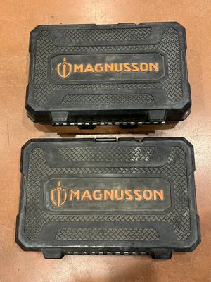 two magnusson cases sitting on top of a wooden table