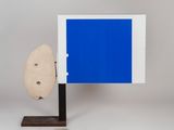 an image of a blue picture frame with a rock on a stand