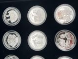 a picture of a display case with twelve different coins