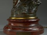 bronze statue of a woman with a dog on a marble base