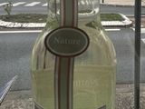 a bottle of wine sitting on a table outside