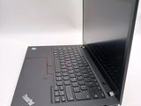 a black laptop computer sitting on a white surface