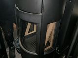 a black stove sitting in the corner of a room