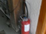 a fire extinguisor sitting on the floor next to a wall