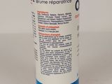 an image of a bottle of liquid on a white surface