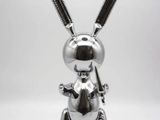 a close up of a silver rabbit statue on a white background