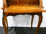 an old wooden desk with a drawer on top of it