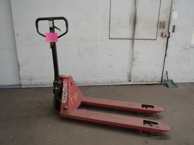 a red pallet with a pink sticker on it