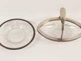 silver plate with a spoon and a glass bowl on a white surface