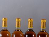 three bottles of wine are lined up on a table