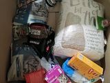 a cardboard box filled with items that include a toilet, toilet paper, and other items