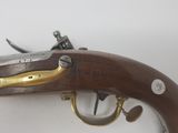 a close up of a gun on a table with a white background