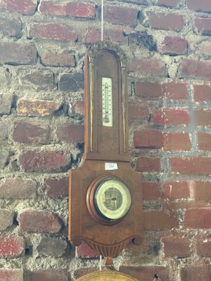 a clock hanging on a brick wall next to a brick wall
