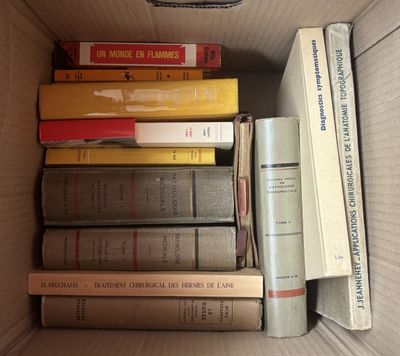 une boîte remplie de livres posés sur le sol