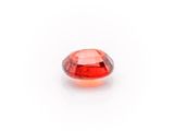 a close up of a red diamond on a white surface