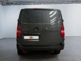 the back of a grey van is parked in a garage