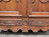 a wooden armoire with ornate carvings on it