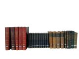 many books that are lined up together on a shelf