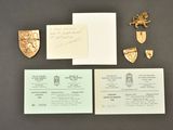 an image of a set of three business cards and a pair of brooches