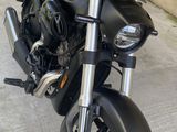 a black motorcycle parked in front of a building