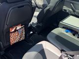 a back seat of a car with a bag in the back