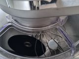 a close up of a mixer with a metal bowl on it