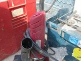 a picture of a red and black drill and some other tools