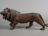 a statue of a lion with its mouth open