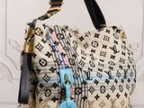 louis vuittou bag with a blue tag on it sitting on a table