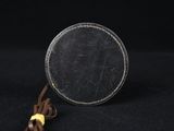 a small toy spider sitting on top of a coin on a black surface