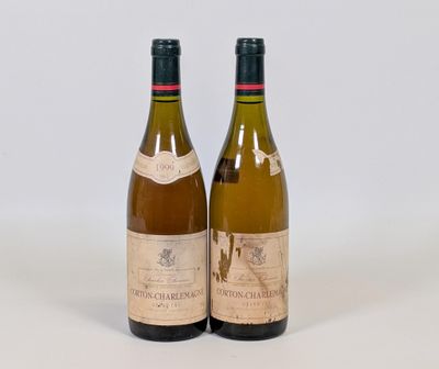 deux bouteilles de vin posées l'une à côté de l'autre sur une surface blanche