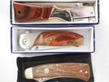 two knives in a box on a white surface