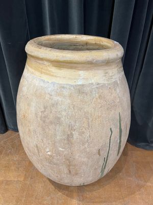 a large stone pot sitting on a wooden table