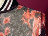 a close up of a mannequin wearing a dress with a floral pattern
