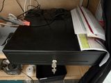 a black metal box sitting on top of a wooden desk